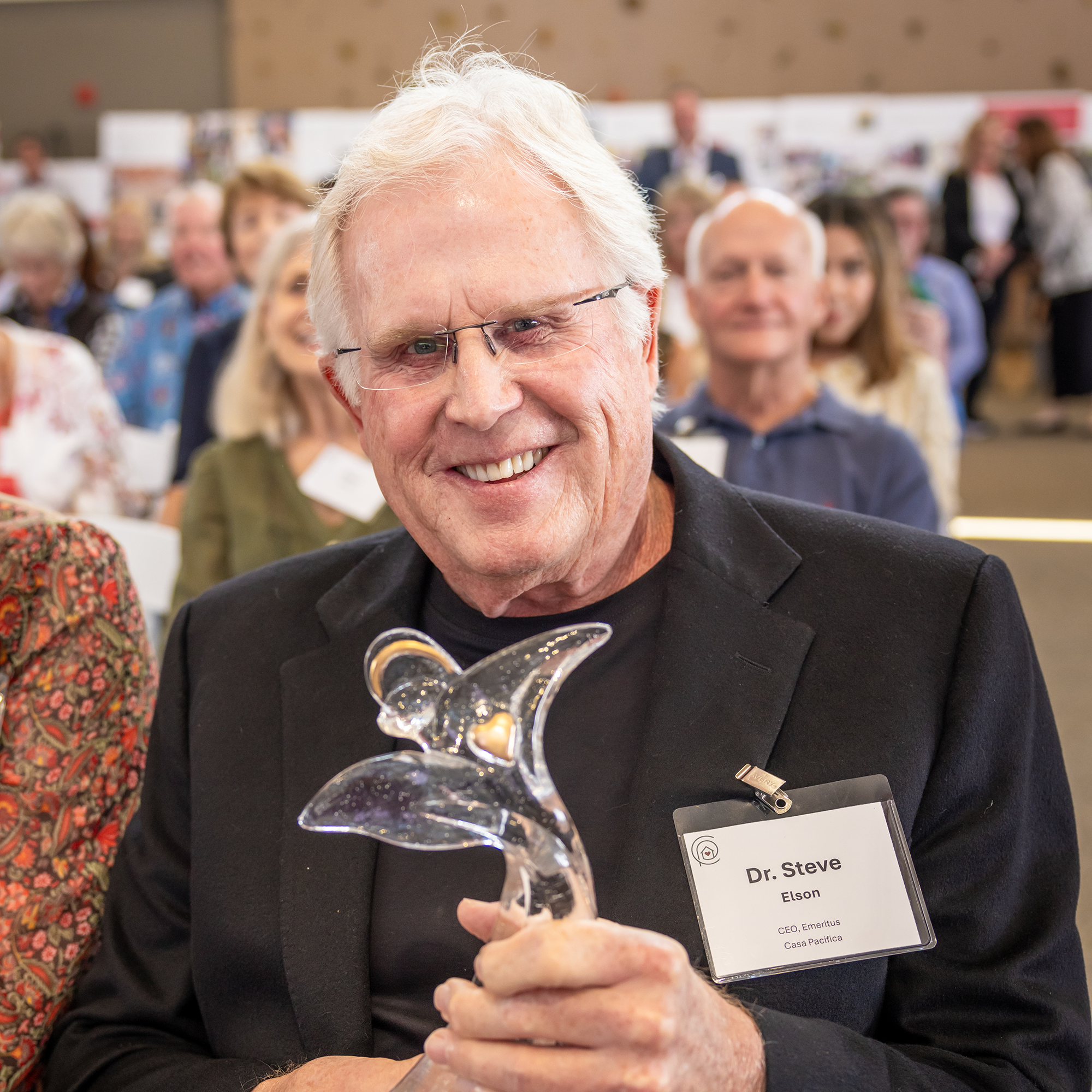 Dr. Steve Elson smiles to camera with his Guardian Angel Award.